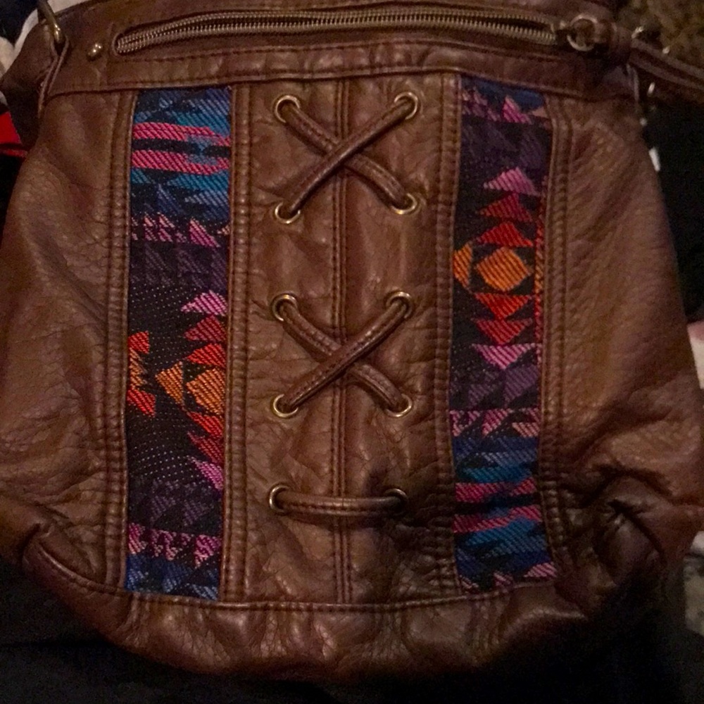 Wallflower leather purse. Lined in brown. 2 main zipper compartments. Never used